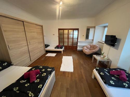 a living room with two beds and a couch at H@M Penzion in Žlutice