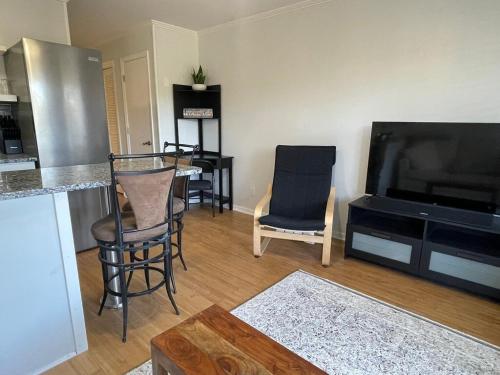 a living room with two chairs and a television at Coastal Getaway Oceanview Condo in Hilton Head in Hilton Head Island