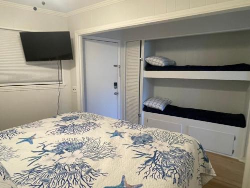 a bedroom with a bed and a bunk bed at Coastal Getaway Oceanview Condo in Hilton Head in Hilton Head Island