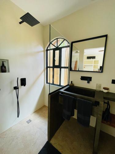 a bathroom with a sink and a mirror at Siroco Villas - Romantic Privet Pool Escape in Tagibo