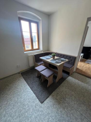a living room with a table and two chairs at H@M Penzion in Žlutice
