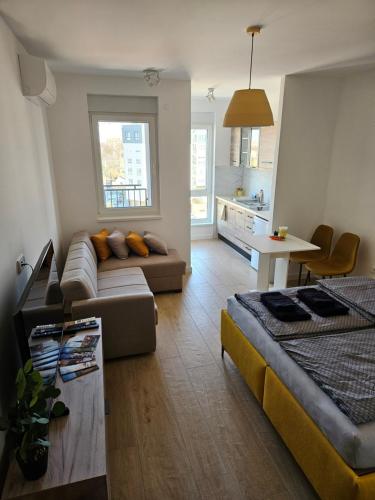 a living room with a couch and a table at Apartman NATALIJA in Subotica