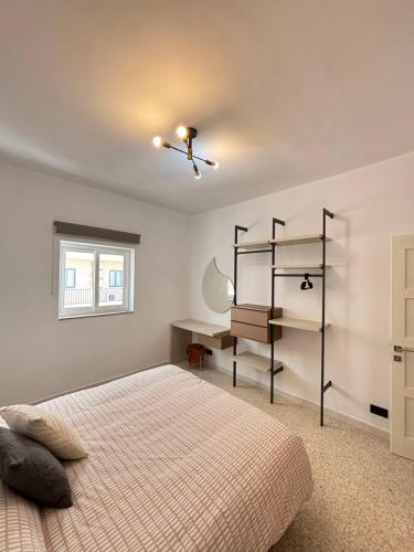 a bedroom with a bed and a desk in it at Sliema Penthouse 3 Ensuite Bedrooms Seaview - Zero55 in Sliema