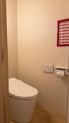 a bathroom with a white toilet in a room at Hills Hotel Gotanda in Tokyo