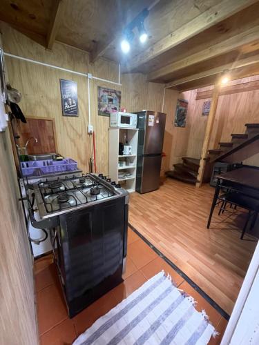 an overhead view of a kitchen with a stove and a piano at Cabañas Diarias in Valdivia
