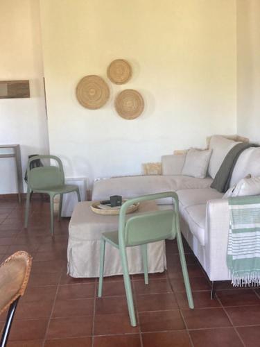 a living room with a couch and a table and chairs at Villa Batsheva in Roumelí