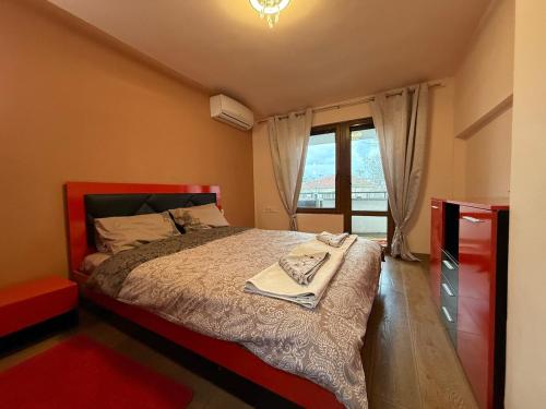 a bedroom with a bed and a window at Two-Bedroom Apartment in the Heart of Burgas, Bogoridi Street in Burgas City