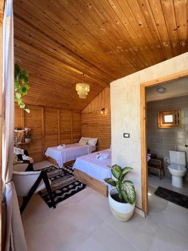 a large room with two beds and a bathroom at Meddur Siwa Oasis in Siwa