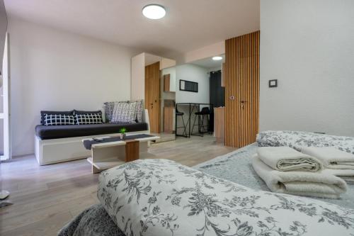 a living room with two beds and a couch at Apartments Villa Sol in Ston