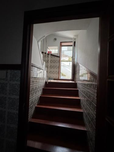 a view through a door of a stairway with a window at House Mariona in Caminha