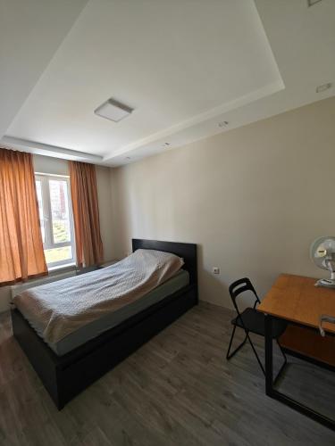 a bedroom with a bed and a desk and a table at Kavoliuko 14 in Vilnius