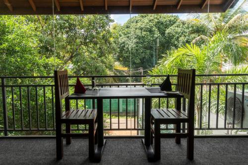 a table and two chairs on a balcony at Hotel Bella Vista in Anuradhapura
