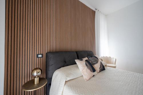a bedroom with a bed and a striped wall at MARAF Rooms in Torre Annunziata