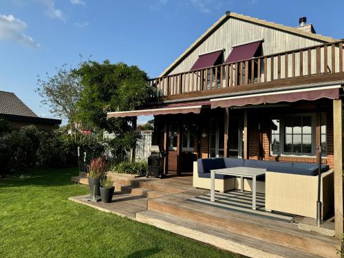 a house with a deck with a table on it at Haus Seeglück am Prüßsee in Güster