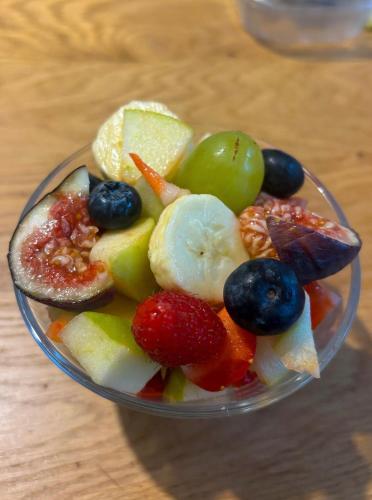 a bowl filled with fruit and vegetables on a table at Villa Emma Malcesine in Malcesine