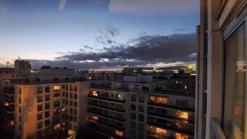 a view of a city skyline at night at Issy Citea Access dayuse Room - Work and Day Rest Timeshare -- 2 min tram - Formule Temps Partagé -- Navette ile d'Issy Avenue Paris 92320 espace nuit in Châtillon