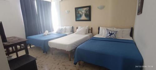 Cama ou camas em um quarto em Hotel Coral