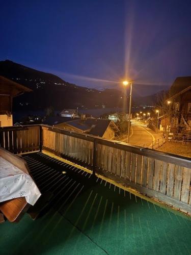 a view of a street at night from a balcony at Bellevue Apartment in Krattigen