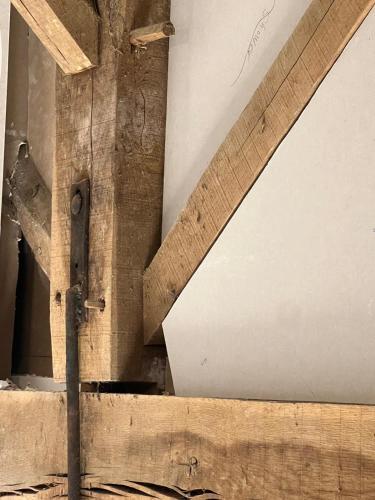 a wooden wall with a beam in a room at Maison Vigneronne - Stay on a vineyard, in the winegrowers cottage in Savigné