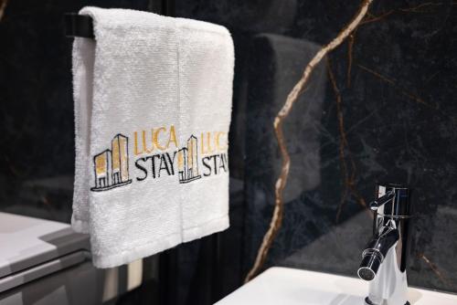 a towel hanging on a wall next to a sink at Visconti Suites - Luca Stay in Milan