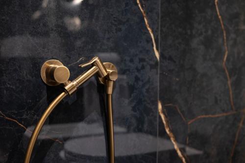 a shower head in a bathroom next to a glass wall at Visconti Suites - Luca Stay in Milan