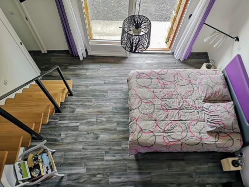 - un salon avec un lit et un escalier dans l'établissement Chambre Familiale, à Saint-Justin