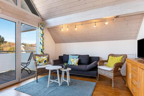 a living room with a couch and chairs at Winzercafé Neipperg in Brackenheim