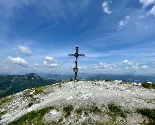 a cross on the top of a mountain at Bauernhütte Niedermaisgut in Eben im Pongau