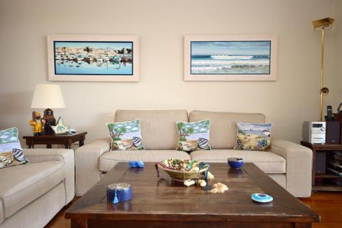 a living room with two couches and a coffee table at Carpos Villa in Aegina Town