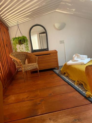 a bedroom with a bed and a dresser and a mirror at Villetta Verde&Mare in Stintino
