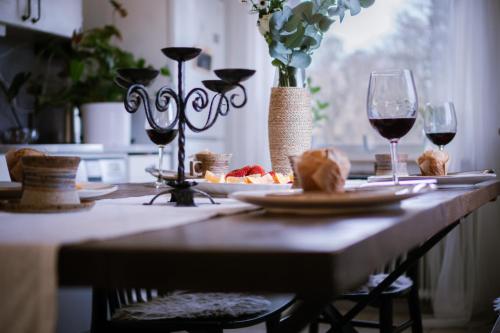 a table with two glasses of wine and a plate of food at HaHa Partllie Center in Gothenburg