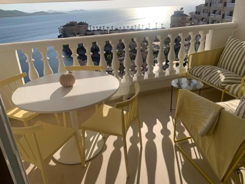 a balcony with a table and chairs and the ocean at Newly renovated apartment in La Manga del Mar Menor