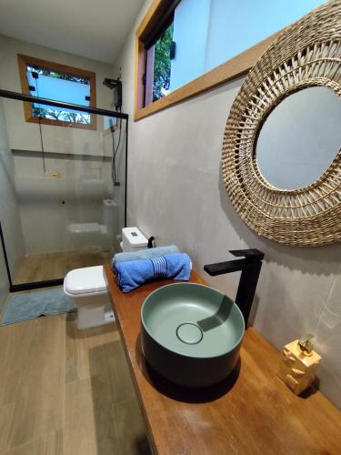 a bathroom with a sink and a mirror on a counter at Loft BeiraMar 1 in Serra