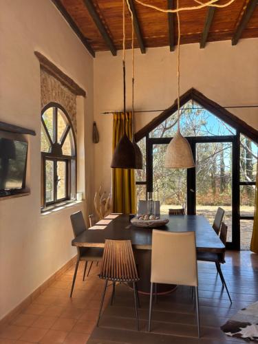 a dining room with a table and chairs at Maison la chèvre By Nath & Lulu in Essaouira