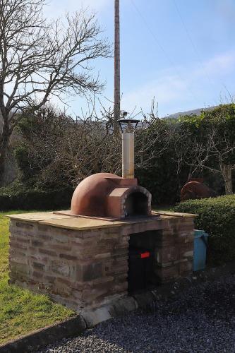 an outdoor brick oven sitting in a yard at Dairy in the Black Mountains in Abergavenny