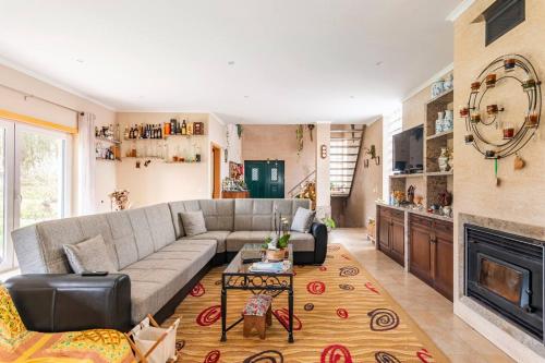 a living room with a couch and a fireplace at Beco do Patalugo in Salir de Matos