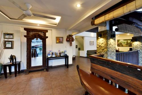 a restaurant with a bench and a mirror in a room at The Khayangan Dreams Villa, Seminyak in Seminyak