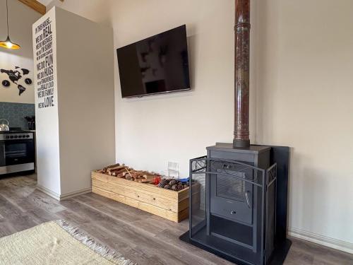 a stove in a room with a tv on a wall at The Gate House in Hogsback