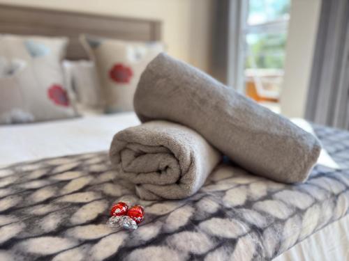 a pile of towels sitting on top of a bed at The Gate House in Hogsback
