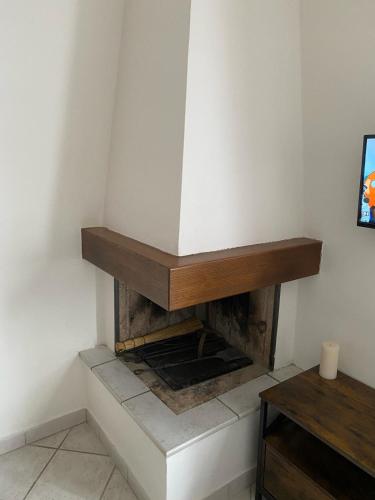 a fireplace in a corner of a room at B&B il Castelletto Siena in Montaperti