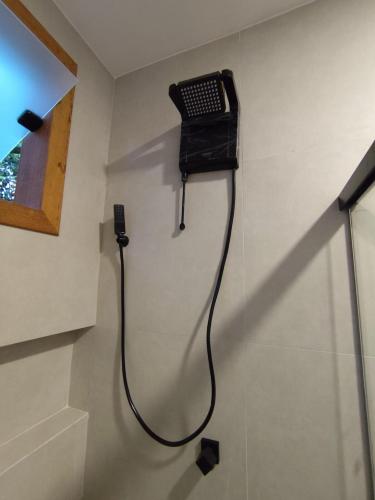 a phone hanging on a wall in a room at Loft BeiraMar 2 in Serra