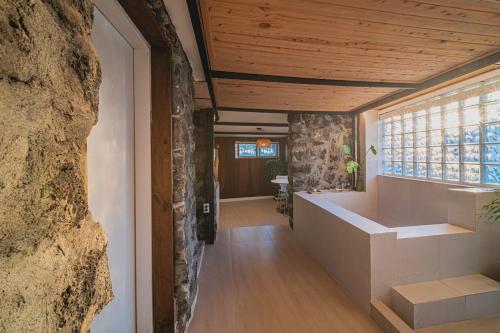 a hallway of a house with a large window at 신흥부부공간b동 in Jeju