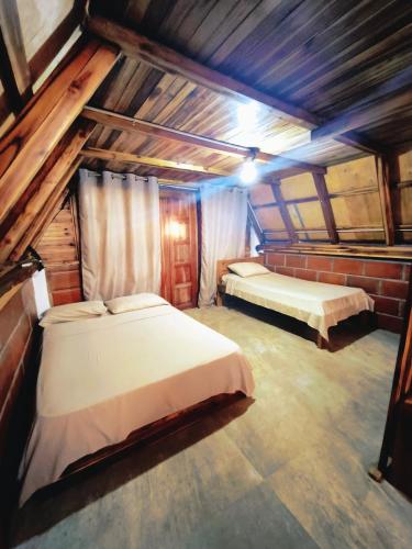 a bedroom with two beds in a attic at Cabañas en Playas Villamil, Bungalows! in Playas