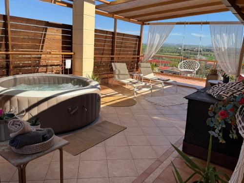 una vasca idromassaggio sul patio di una casa di Wait 'N Sea, Jacuzzi, Luxury Stone House a Epanomi