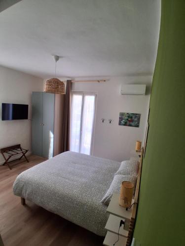 a bedroom with a large bed and a window at Che sarà mai in Santa Maria degli Angeli
