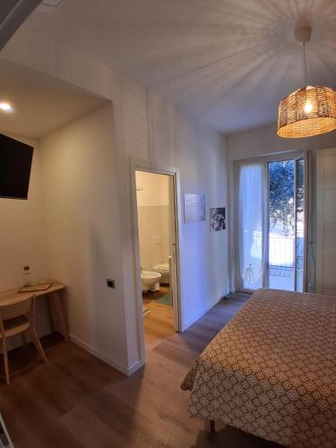 a bedroom with a bed and a door to a bathroom at Che sarà mai in Santa Maria degli Angeli