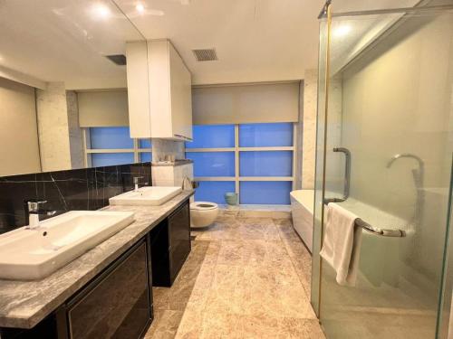 a bathroom with two sinks and a shower at The Suites At Platinum KLCC in Kuala Lumpur