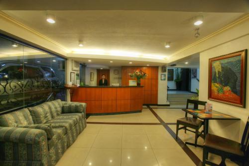 a living room with a couch and a table at Fersal Hotel - Manila in Manila