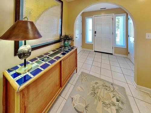 a room with a counter with a lamp on it at A Charm of Finches in Surf City