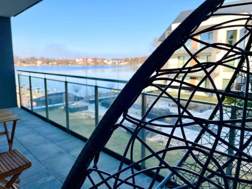 a view of a balcony with a view of the water at Apartament ŻURAW z widokiem na jezioro Drwęckie ROYAL APARTS OSTRÓDA in Ostróda